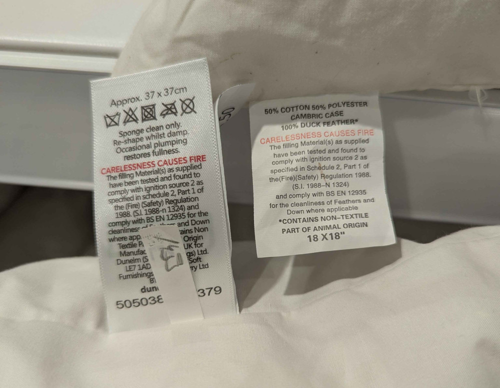 Two cushions in the same shop showing metric and imperial measurements