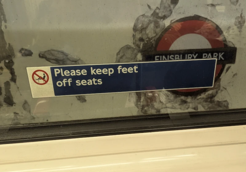 Window sticker notice on tube train with horrific formatting